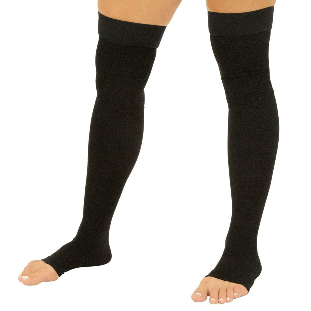 Black knee-high socks worn by a person on a white background