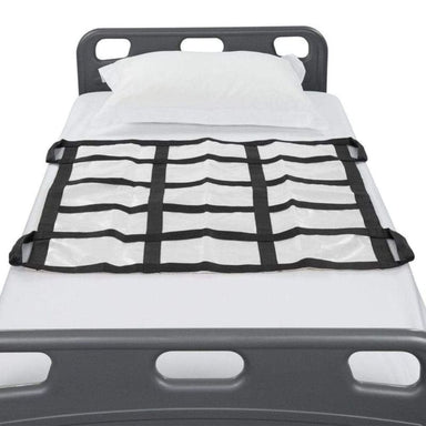 Grid-like cargo net on a truck bed with white bedding