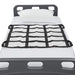 Grid-like cargo net on a truck bed with white bedding