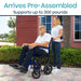 Man using a wheelchair with a woman standing beside him, outdoors.