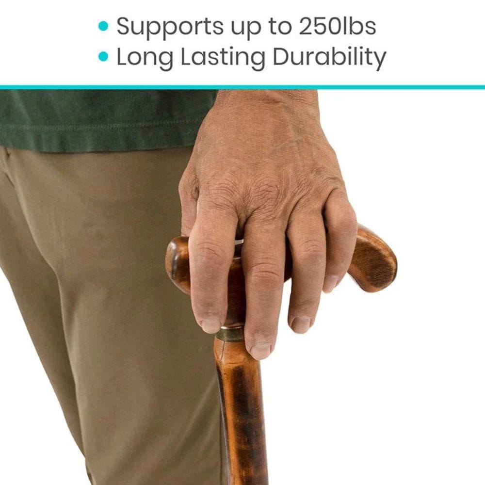 Hand holding a wooden walking stick with text about weight support and durability.