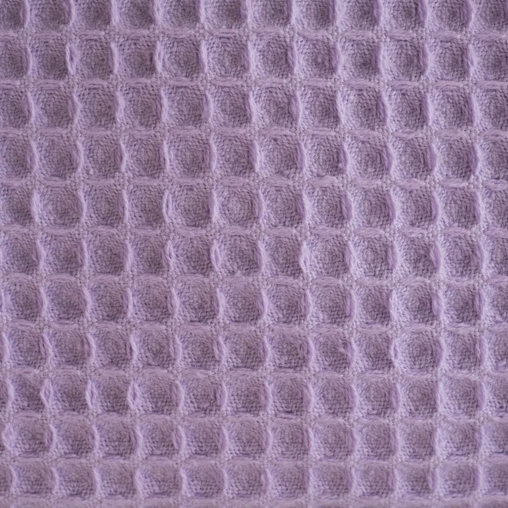 Close-up of a textured purple fabric with a waffle pattern