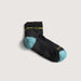 Black sock with blue toes and yellow accents on a light gray background