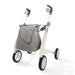 Gray bag attached to a white and gray stroller on a white background